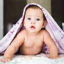 baby under purple blanket