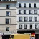 yellow bus in front of white concrete building