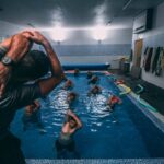 people stretching inside pool room