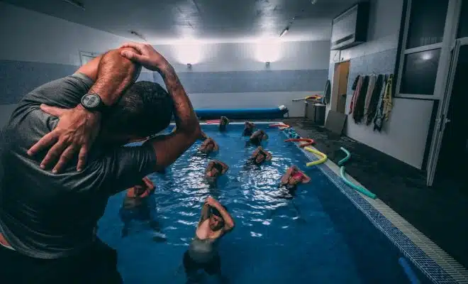 people stretching inside pool room