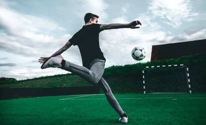 man playing soccer during daytime
